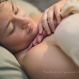 In a series of images that capture the connection and bliss between breastfeeding mother and child, the newborn baby reaches for his mother's face.