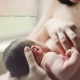In a series of images that capture the connection and bliss between breastfeeding mother and child, this newborn grasps on to his mother's finger.