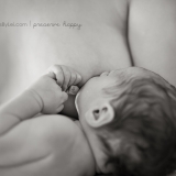 In a series of images that capture the connection and bliss between breastfeeding mother and child, this newborn clenches her fists together.
